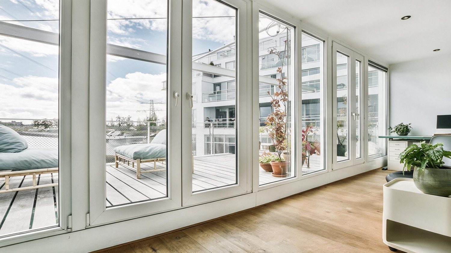 Floor-to-ceiling DoRB uPVC windows in a bright, modern Kerala home interior