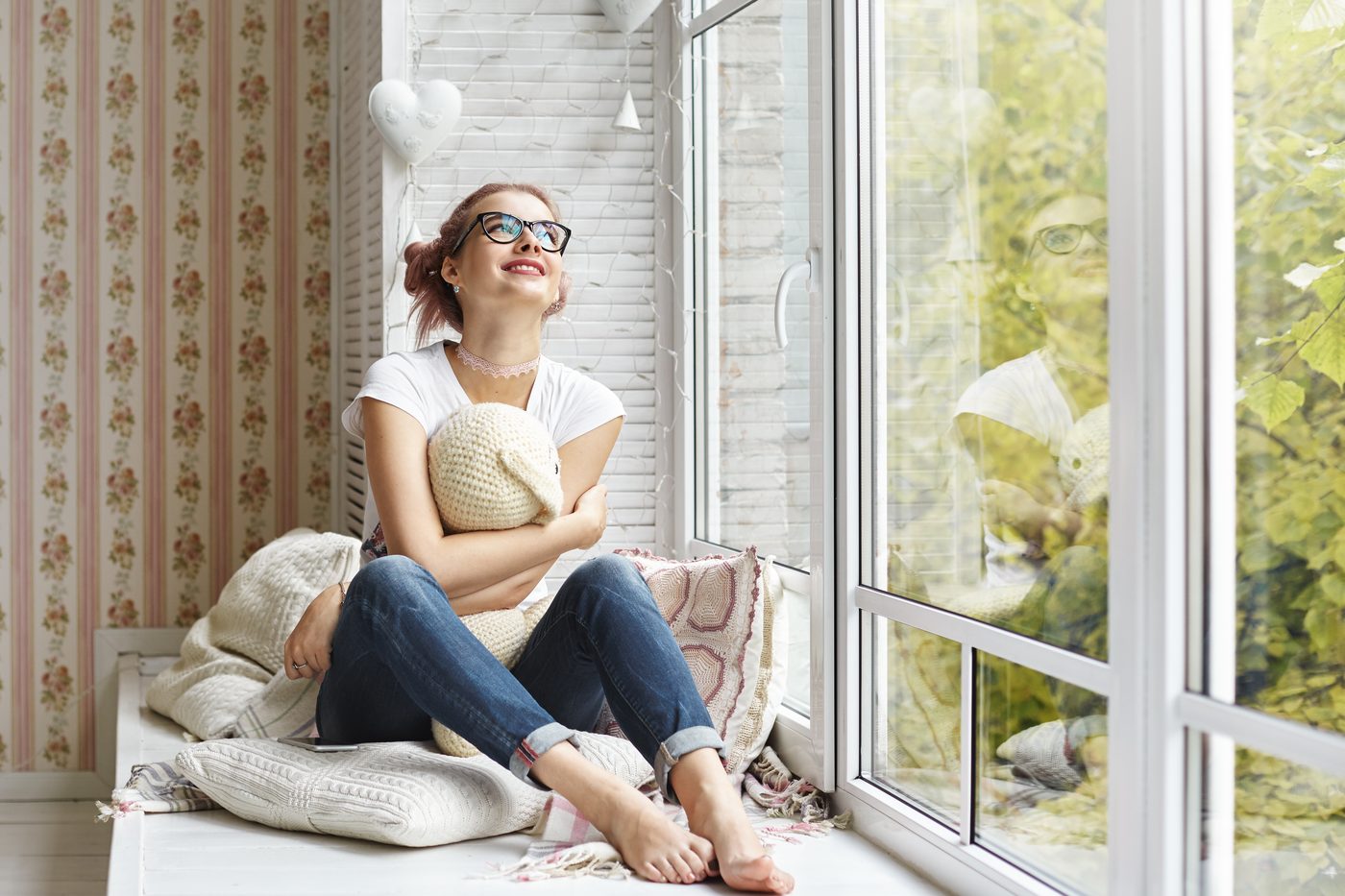 Sliding uPVC window opening a bedroom onto a garden view